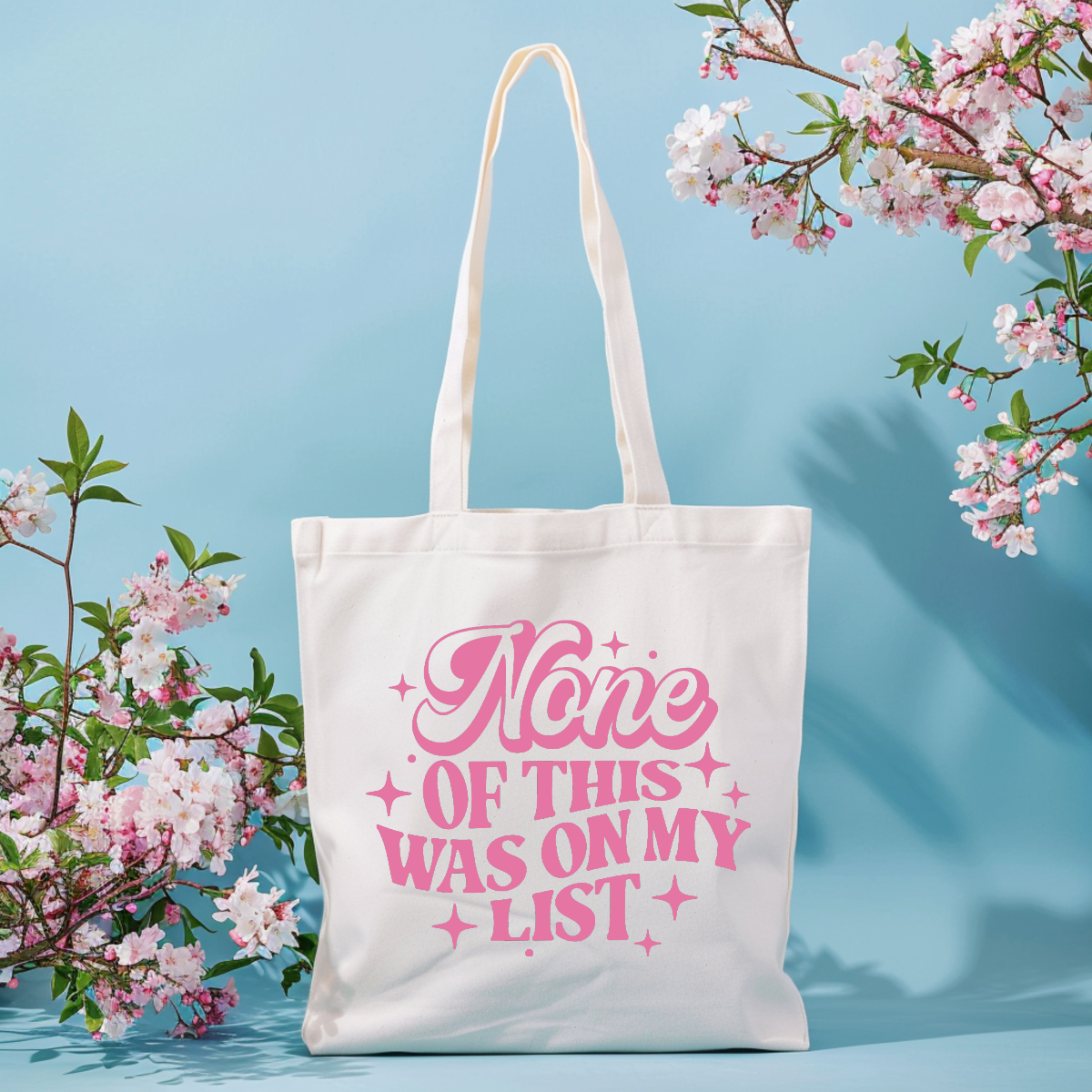 Funny shopper tote bag with “None of This Was On My List” surrounded by spring flowers