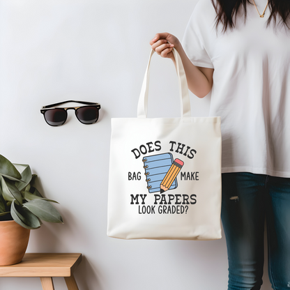 Funny teacher tote bag with “Does This Bag Make My Papers Look Graded” design – model holding bag